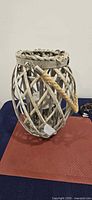 Front view of grey-washed wooden lattice lantern with rope handle