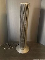 Front view of tower air purifier showing ventilation slats and base