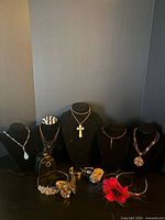 Group view of all necklaces on busts, bracelets, earrings, headbands and travel case