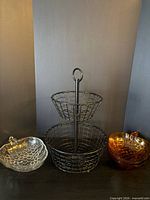 Full lot: wire basket centred, clear bowl left, amber bowls right