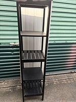 Front view of tall black 5-shelf etagere