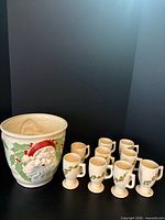 Group shot of Santa planter with nine holly mugs