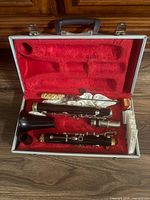 Clarinet parts and accessories arranged in red-lined case