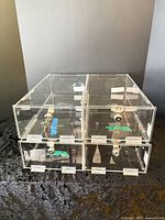 front view showing four clear acrylic locking drawers