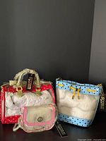 Group shot of all three Score! clear PVC handbags