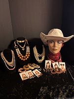 Group shot of hat, jewelry displays, bracelets and earrings