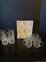 Full lot showing highball glasses, boxed champagne flutes, Fantasia cups