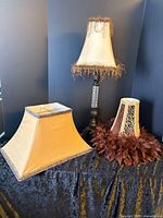 Lamp assembled with bell shade and two additional shades visible
