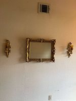 Mirror and both sconces mounted on wall