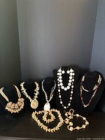 All seven jewellery pieces displayed on stands and table