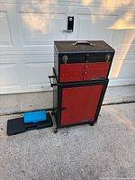 Full view of rolling cart with top chest, blue and black tool boxes on ground