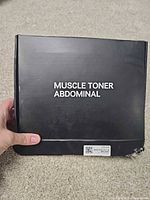 Front of black box labeled Muscle Toner Abdominal