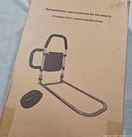 Front of box showing bed assist rail illustration and text