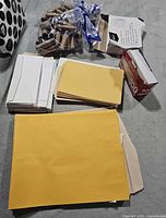 Mixed envelopes, coin rolls bag, box of #10 envelopes visible