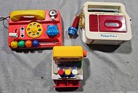 Three Fisher-Price toys grouped together