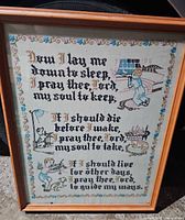 Full view of framed cross-stitch sampler