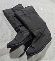 boots laid flat showing overall design, wedge heel and shaft
