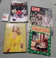 Lot overview: four magazines, sealed trading-card pack, loose cards