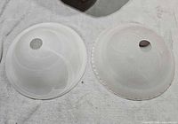 Top view of both frosted glass shades showing patterns and mounting holes
