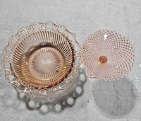 Top view of both pink glass pieces showing patterns and forms