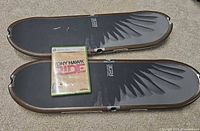 Two balance boards with game case placed on top showing overall lot