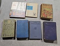 Overhead view of seven vintage hardcover books in two rows