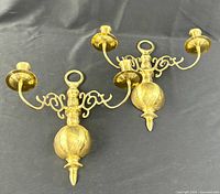 Pair of brass double-arm wall sconces side by side