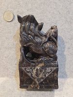 Front angled view showing entire carving and coin for scale