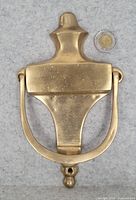 Front view showing overall design and coin for scale