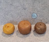 Three beads next to dime for scale