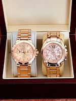 Both wristwatches in display box, showing overall appearance