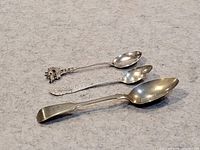 Three spoons laid out to show size and design differences