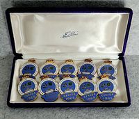 Open presentation case displaying ten identical 1965 Canada curling medals