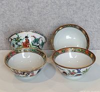 Four small Famille Rose bowls grouped, showing interiors and exteriors