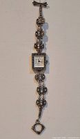 Full view of vintage ladies wristwatch showing dial, decorative band, and toggle clasp