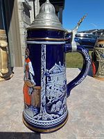 Full view of stein showing pewter lid and cobalt body