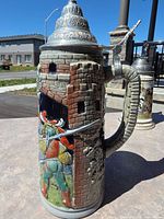 Full view showing pewter lid, handle, relief castle and knight scene