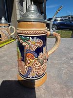 Full stein profile showing pewter lid, handle and relief work