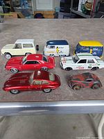 Group shot of seven diecast vehicles on tabletop