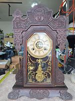 Full view of carved wood Waterbury mantel clock