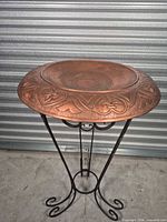 assembled hammered copper bowl on wrought iron stand
