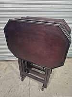 Set of four folded trays on stand