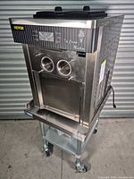 Front three-quarter view of Vevor soft serve ice cream machine on rolling cart