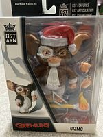 Front of sealed window box showing Gizmo figure, Santa hat, trumpet, torch accessory and extra hands.