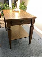Three-quarter view of walnut veneer side table showing overall design