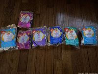 Front view of seven sealed Teenie Beanie Baby bags showing series numbers and colours