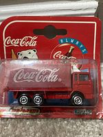 Front view of sealed Majorette Coca-Cola truck on blister card