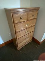 Front view of dresser showing all drawers and hardware