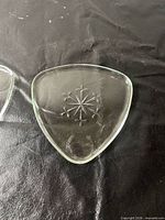 Close-up of first ashtray showing starburst design and triangular shape