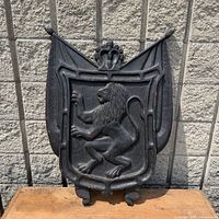 Full view of carved wooden lion shield plaque